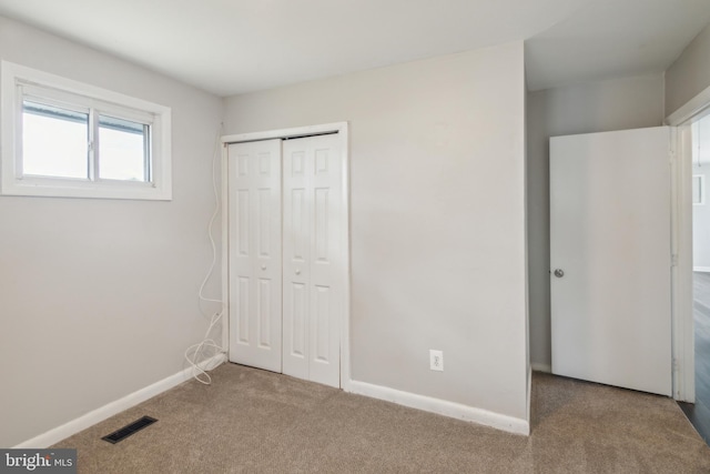 unfurnished bedroom featuring a closet and carpet