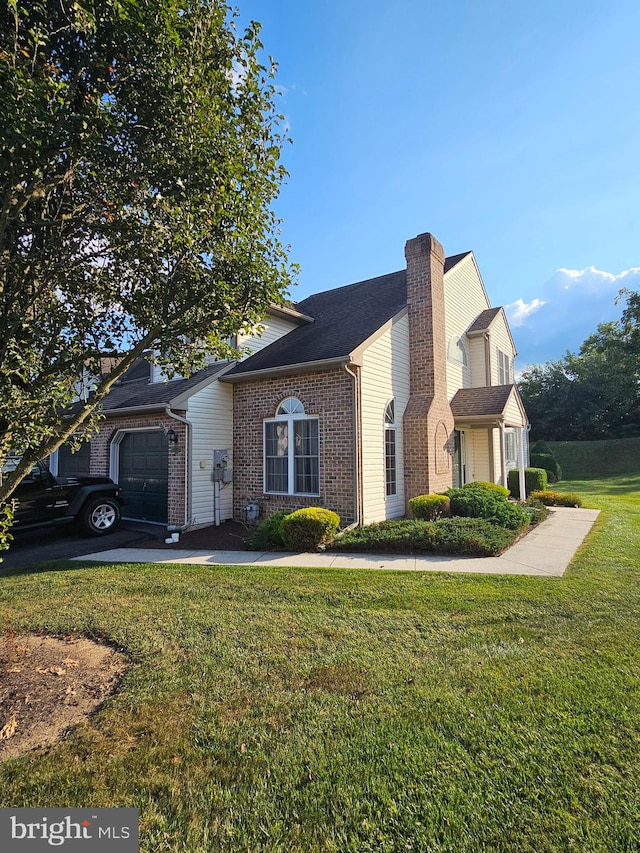 view of front of property with a garage and a front yard