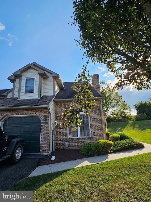 view of front of home with a front yard and a garage