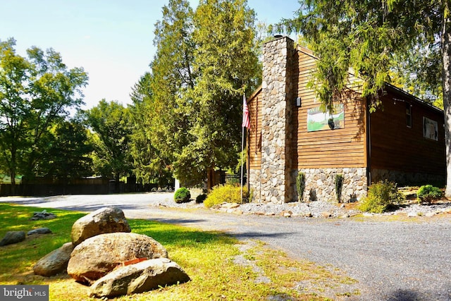 view of side of home with a lawn