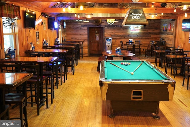 playroom with wood walls, pool table, lofted ceiling, and hardwood / wood-style flooring