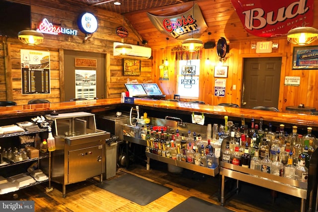 miscellaneous room featuring hardwood / wood-style flooring, vaulted ceiling, bar, wood walls, and an AC wall unit