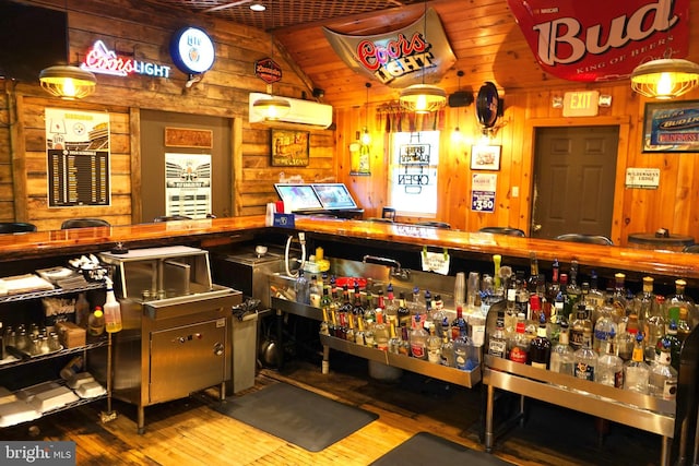 interior space featuring wooden walls, wood finished floors, and a wall mounted AC