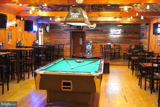 recreation room with a bar, wood finished floors, pool table, and wood walls