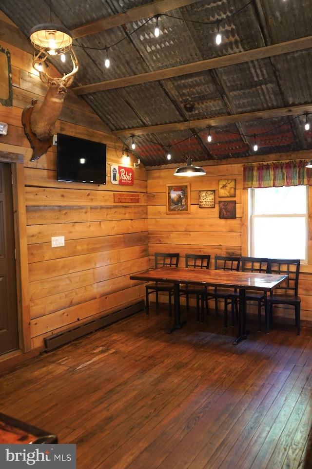 dining space with wooden ceiling, dark wood-type flooring, lofted ceiling, and wooden walls