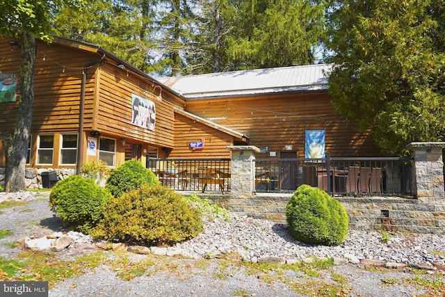 rear view of property with metal roof