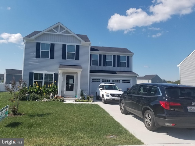 view of front of house with a front yard and a garage