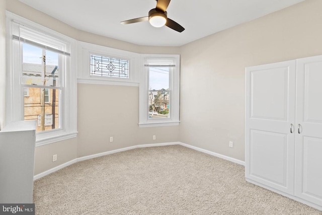 unfurnished bedroom with light carpet and ceiling fan