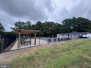 view of pool featuring a pergola and a yard