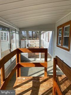 unfurnished sunroom with wooden ceiling