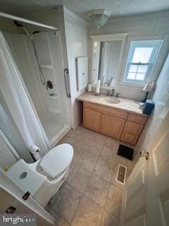 bathroom with a shower, vanity, and toilet