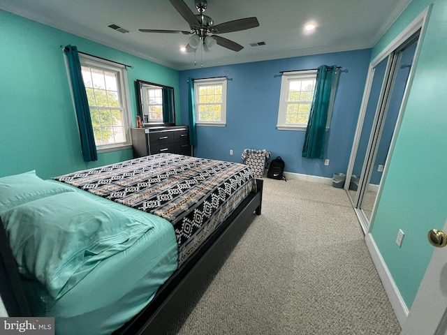 bedroom with a closet, ceiling fan, and carpet floors