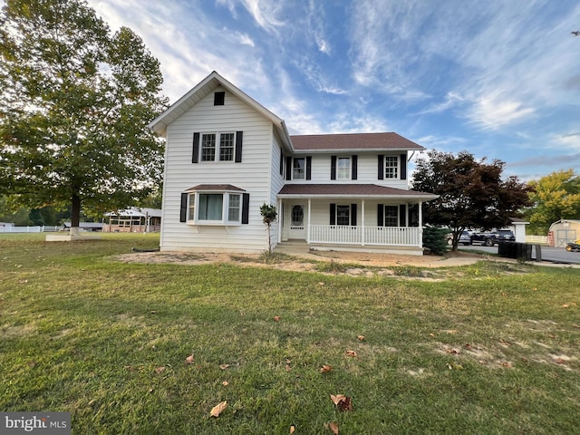 view of front of home with a porch and a front yard