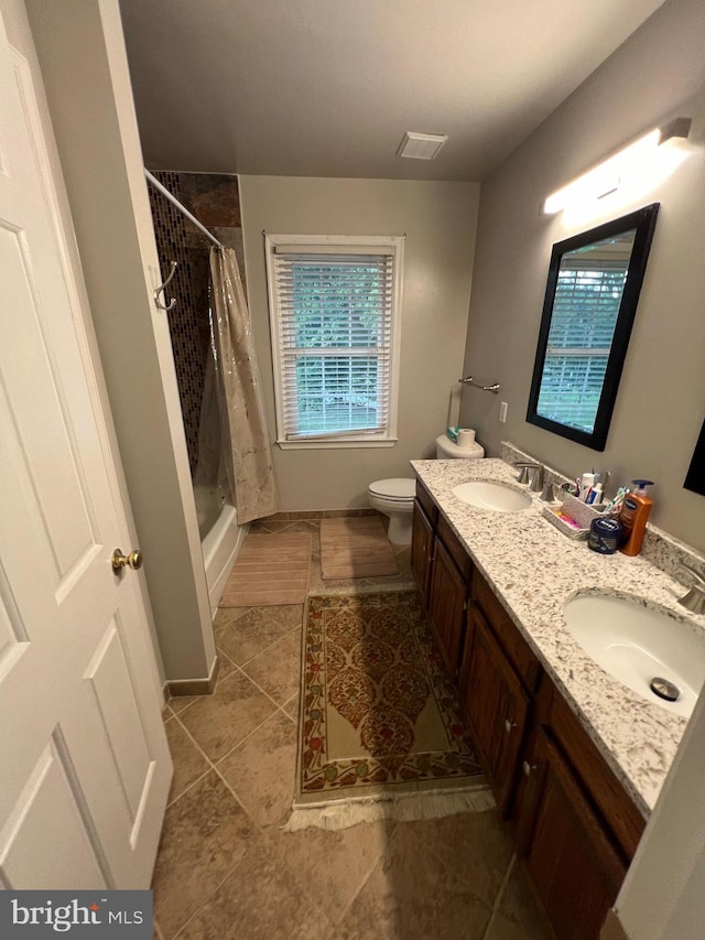 bathroom with tile patterned floors, a shower with shower curtain, toilet, and vanity