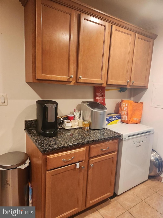 kitchen featuring dark stone counters and light tile patterned floors