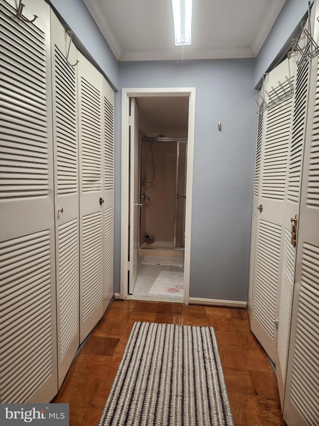 hall featuring dark parquet flooring and crown molding