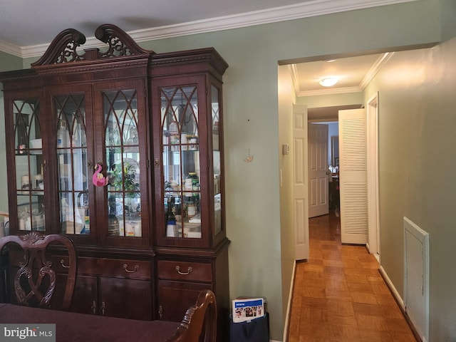 hallway featuring light parquet floors and ornamental molding