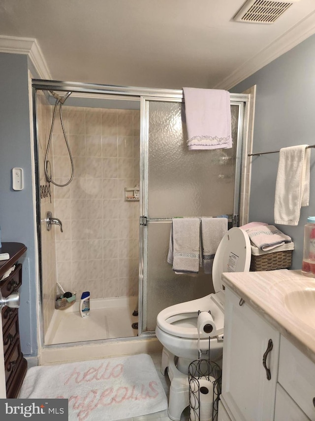 bathroom with crown molding, vanity, toilet, and an enclosed shower