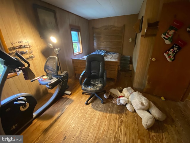 home office featuring wood walls and hardwood / wood-style floors