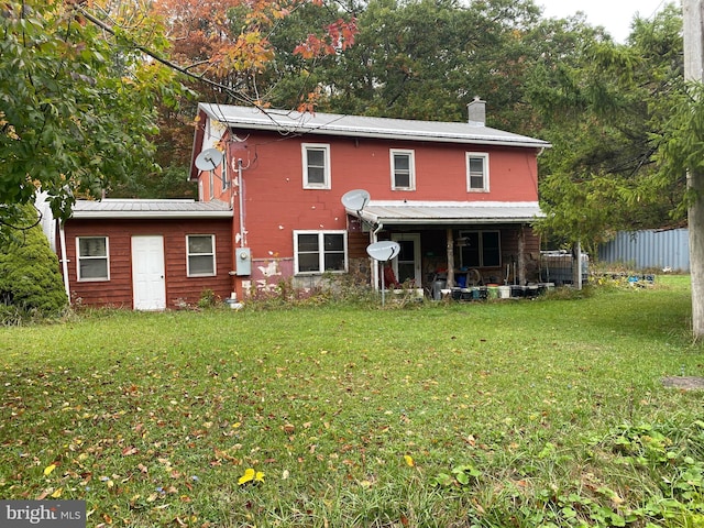 back of house with a lawn