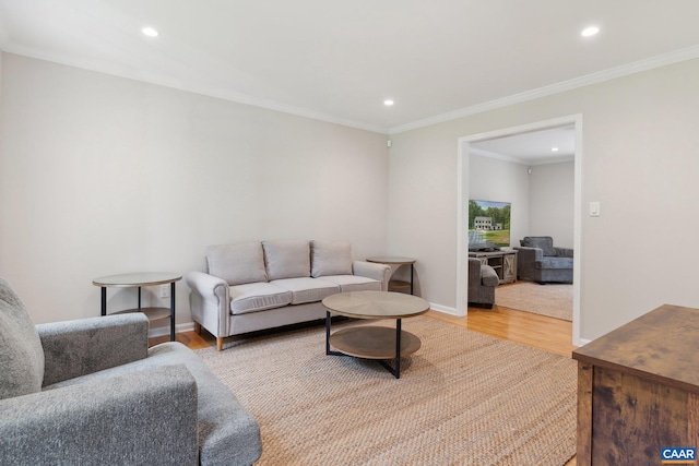 living room with ornamental molding and hardwood / wood-style floors