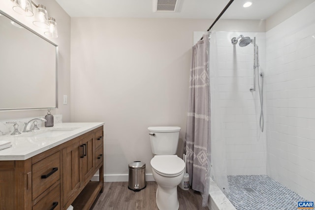 bathroom with walk in shower, toilet, hardwood / wood-style flooring, and vanity