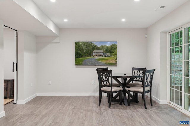 dining area with light hardwood / wood-style flooring