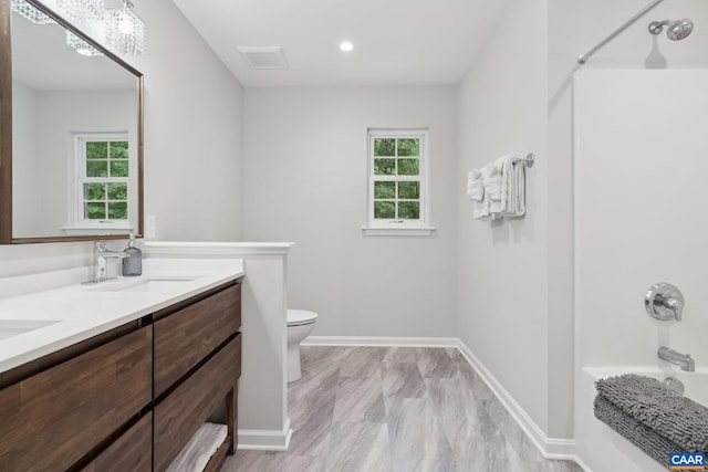 full bathroom featuring vanity, toilet, and bathtub / shower combination