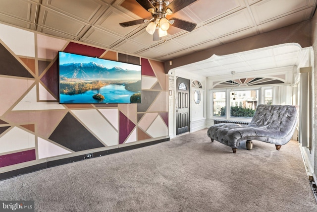 unfurnished living room featuring ceiling fan and carpet floors