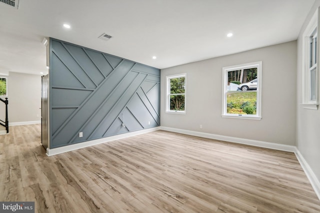 unfurnished room with light wood-type flooring