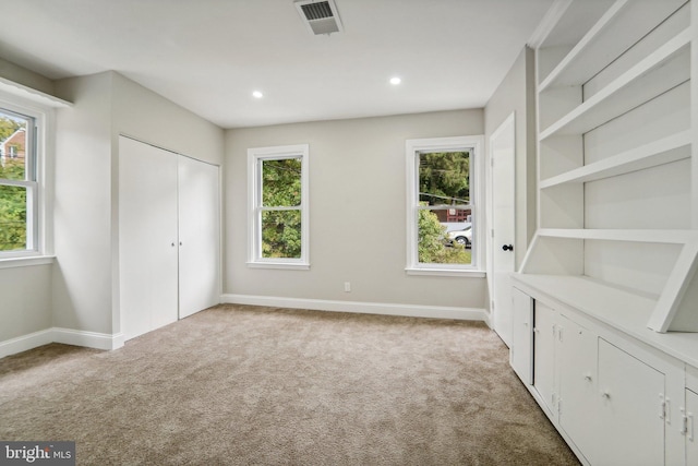 unfurnished bedroom with light colored carpet