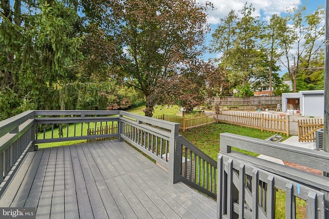 wooden deck featuring a yard