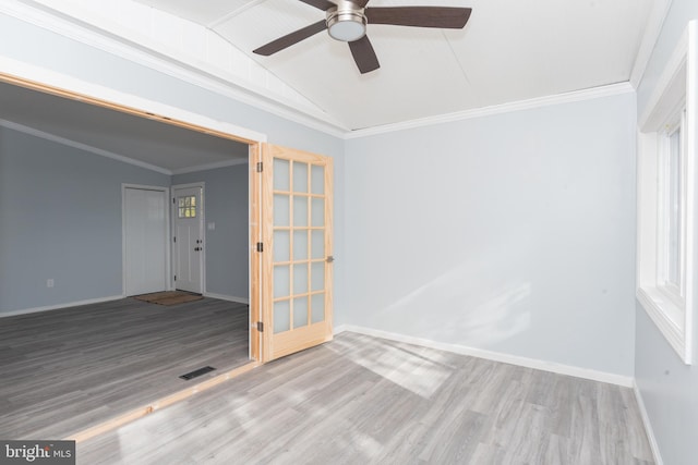 spare room with ornamental molding, vaulted ceiling, hardwood / wood-style flooring, and ceiling fan