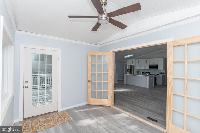 doorway to outside featuring ceiling fan, wood-type flooring, and vaulted ceiling