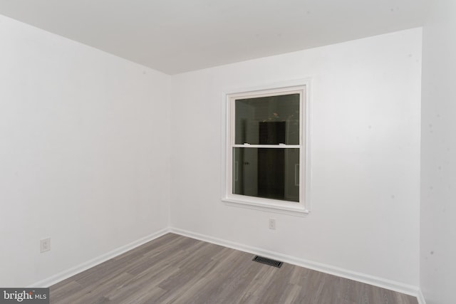 spare room with wood-type flooring