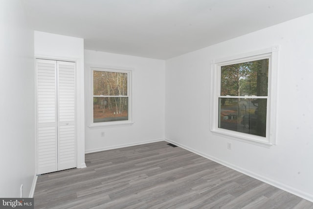 unfurnished bedroom featuring light hardwood / wood-style flooring and a closet