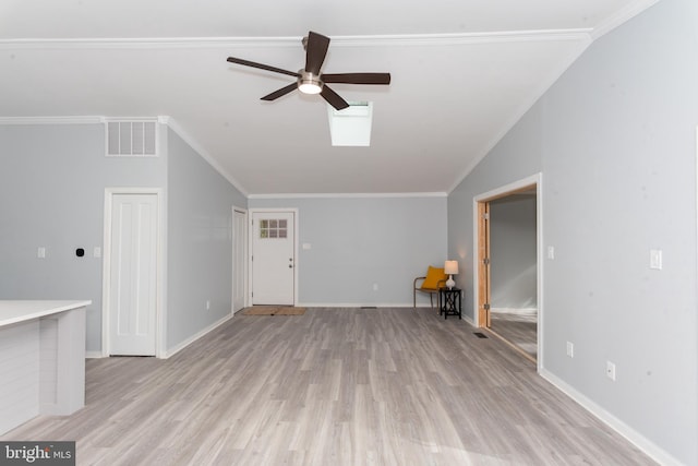 unfurnished living room with a fireplace, ornamental molding, light hardwood / wood-style flooring, ceiling fan, and vaulted ceiling