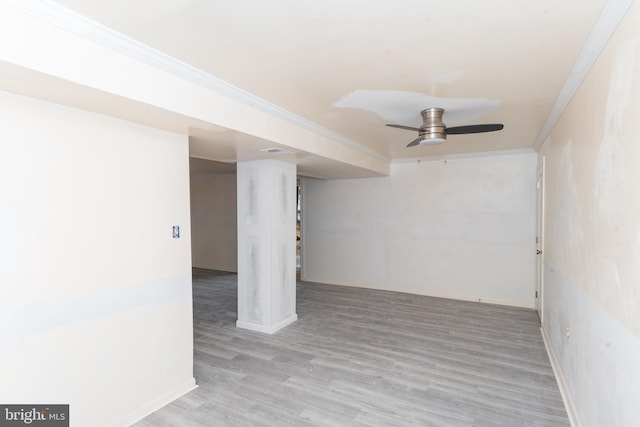 basement with crown molding, hardwood / wood-style flooring, and ceiling fan