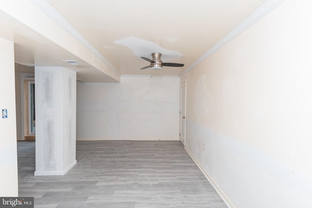 empty room with ceiling fan, crown molding, and light hardwood / wood-style flooring