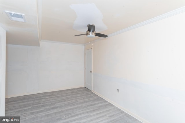 spare room featuring ceiling fan, ornamental molding, and light wood-type flooring