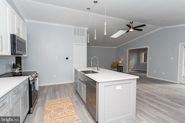 kitchen featuring hanging light fixtures, appliances with stainless steel finishes, sink, ceiling fan, and a kitchen island with sink