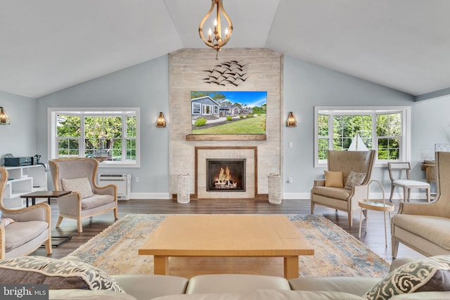 living room featuring a wall mounted air conditioner, lofted ceiling, dark hardwood / wood-style flooring, and a tile fireplace