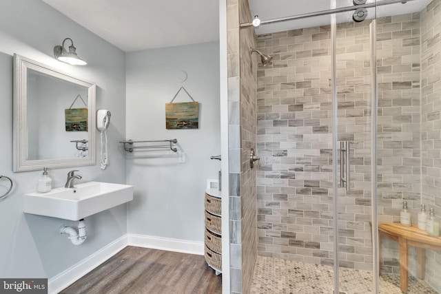 bathroom with sink, hardwood / wood-style floors, and an enclosed shower