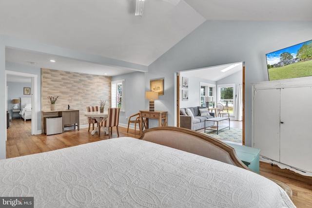 bedroom featuring light wood-type flooring and lofted ceiling