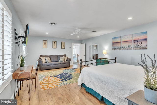 bedroom with light hardwood / wood-style flooring and ceiling fan