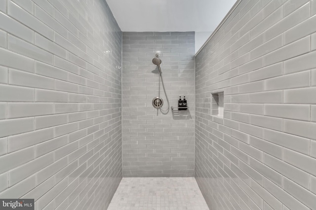 bathroom with tiled shower