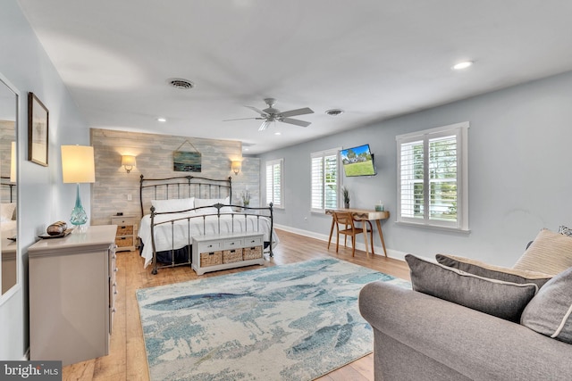 bedroom with light hardwood / wood-style floors and ceiling fan