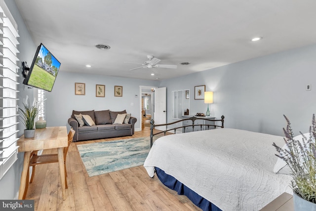 bedroom with light hardwood / wood-style floors and ceiling fan