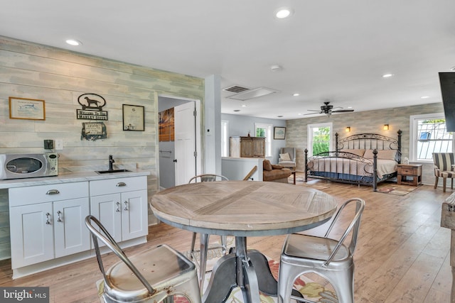 dining room with light wood-type flooring and ceiling fan