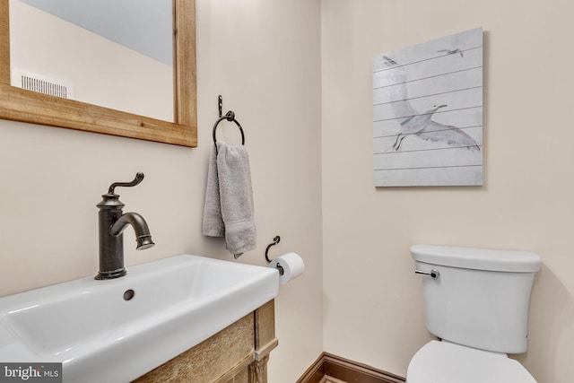 bathroom featuring vanity and toilet